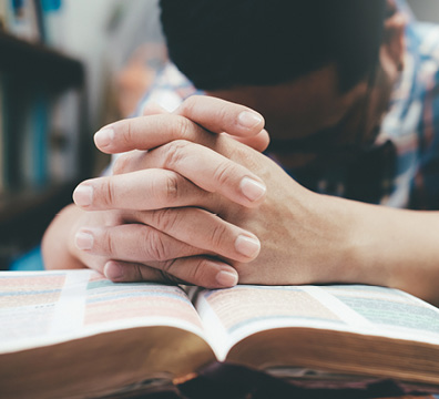 Man praying with Bible